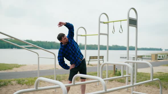 Young Strong Man Exercising on the Beach alt