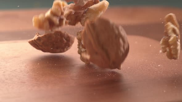 Walnuts falling onto wooden surface in super slow motion.  Shot on Phantom Flex 4K high speed camera