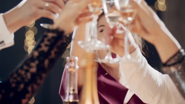Closeup Portrait of Asian Girl Raising Glass of Champagne and Clinking Glasses with Aryone at Party alt