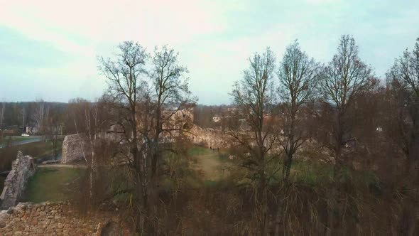 Medieval Castle the Town of Dobele on the West Bank of the River Berze in Winter. Aerial 4K Video alt