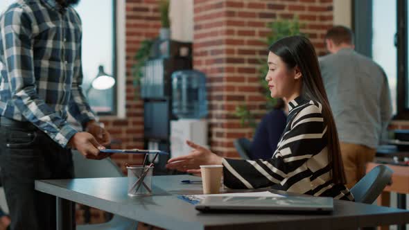 Asian Recruiter Greeting African American Man at Job Interview alt