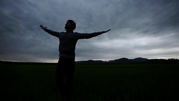 Young Man Enjoying Life Under Cloudy Evening Sky