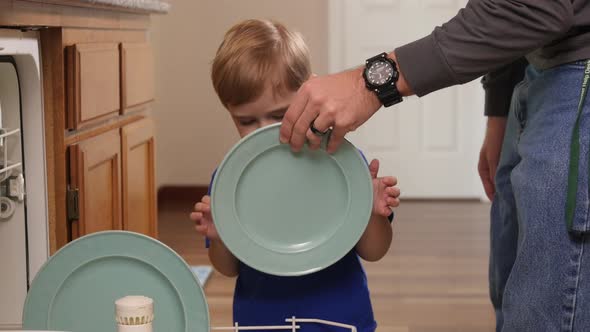 Father and Son loading dish washer together