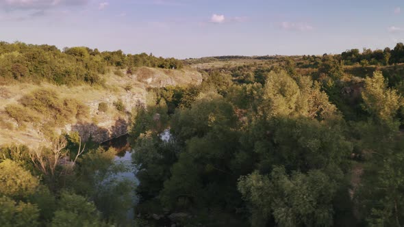 Aerial Shot of Canyon with River During Sunny Day alt