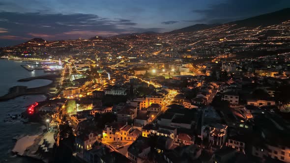 Flying Over Coastline in Evening Funchal Blue Sunset Sky and City Lights alt
