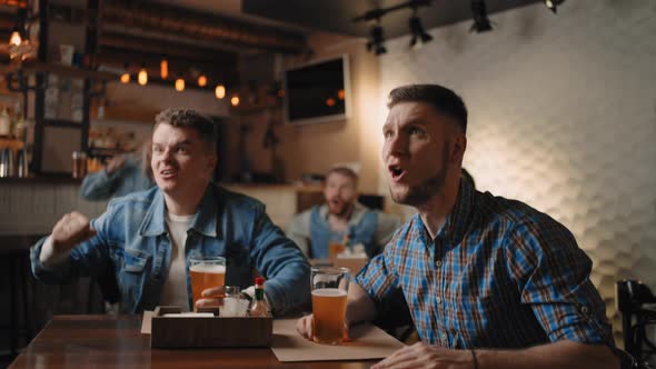 A Group of Men and Women in a Pub Together Cheer for Their National Team at the World Cup in alt
