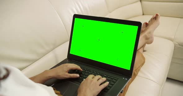 Woman with Laptop Chromakey on Sofa