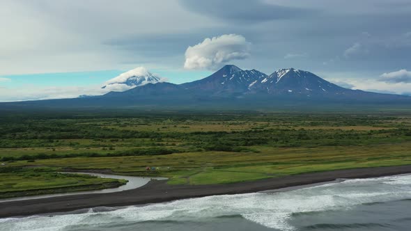 Beach with Black Sand and Volcano alt