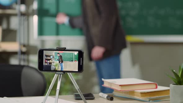 European Elementary School Male Teacher Teach Math Online Through Webcam in Classroom alt