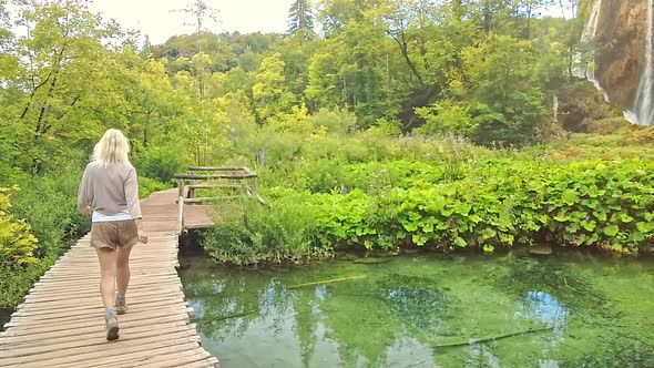 Woman Walking in Plitvice Lakes National Park alt