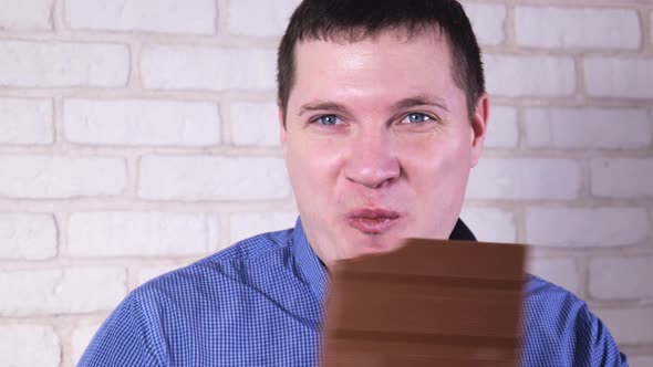 Man Eating Milk Chocolate Closeup