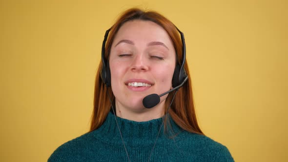 Young Woman in Headset with Microphone Over Yellow Background Isolated