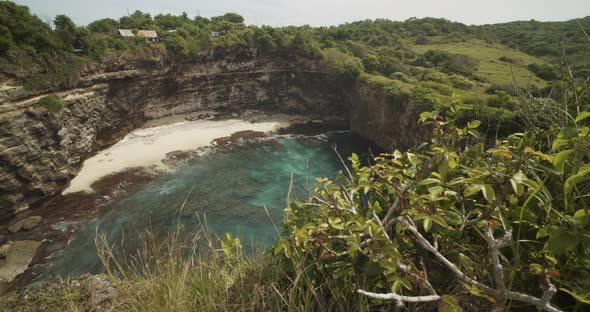 Reveal of a Stunning Secluded Tropical Sandy Beach with Blue Sea and Steep Ocean Cliffs at Broken alt