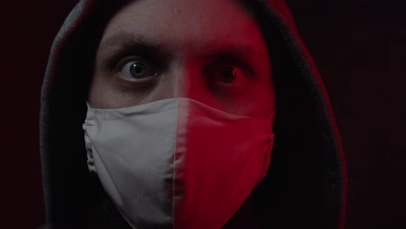 A Man in a Medical Mask Is Scared By a Coronavirus alt