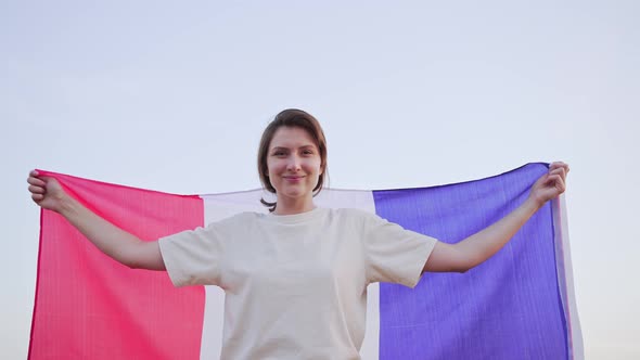 A Young Woman Holds the National Flag of France