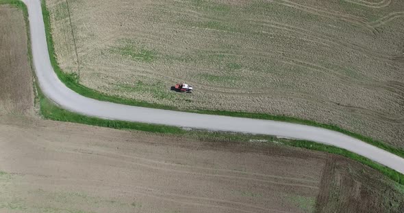 Aerial view, Farmer Drives Old Tractor Sow Buckwheat Seeds