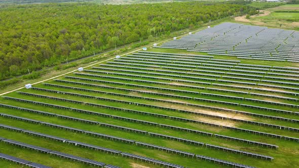 Aerial View of Big Sustainable Electric Power Plant with Many Rows of Solar Photovoltaic Panels for alt