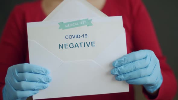 Woman Holding Negative Antigen Detection Test for Covid-19