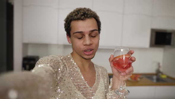 A Guy in Fancy Dress Doing Looking to the Camera Recording Video with Mobile alt