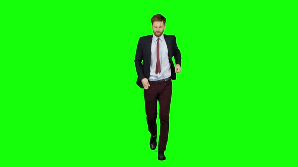 Man Is Running a Telephone Rings To Him and He Talks. Green Screen alt