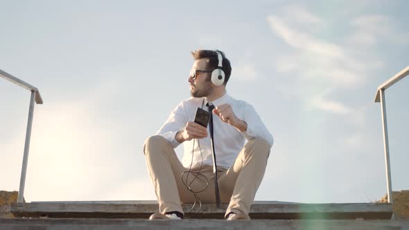 Businessman Relaxing Enjoying After Good News Having Fun Work Break Outdoors. Man Listening To Music alt