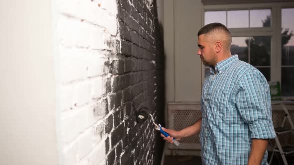 Man Making Repairs at Home Painting Paint Roller Wall White Paint
