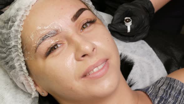 The Master Applies a Special Dark Pigment for Coloring Eyebrows alt