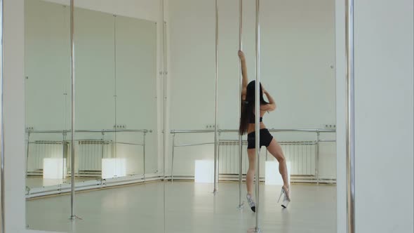 Beautiful Woman Performing Pole Dance in High Heels Shoes alt