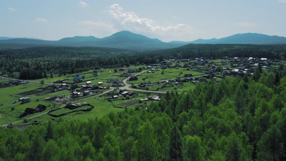 Aerial View of Mountain Range in Ural and Little Households alt