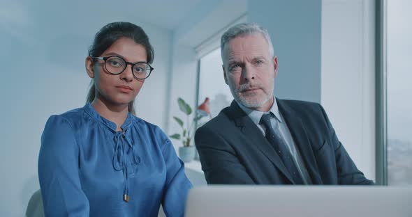Multi racial staff members of international company looking at the camera alt