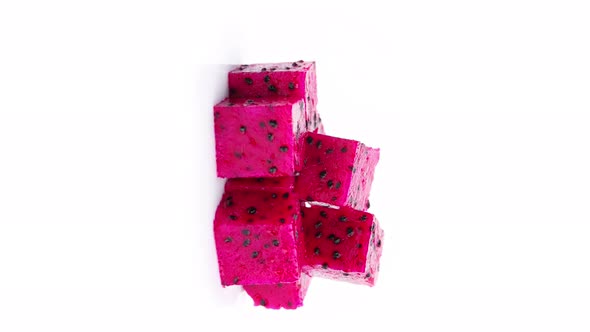 Red Dragon fruit (Pitaya) cut pieces, cubes isolated on white background.