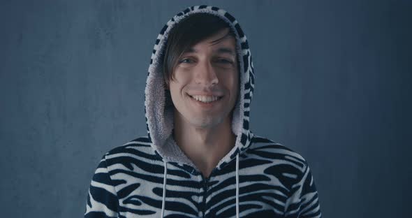 Portrait of Young Man in Kigurumi Zebras on Gray Background