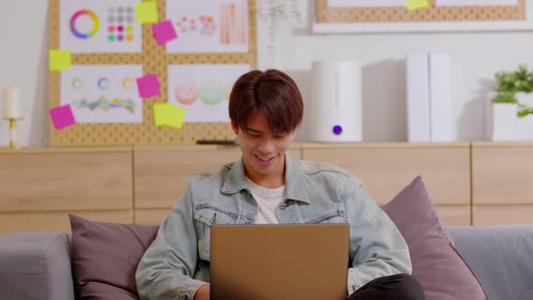 Entrepreneur handsome business asian man wear blue shirt lying on couch alt