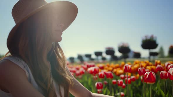 Model Posing in Spring Flower Field in Bright Sunshine alt