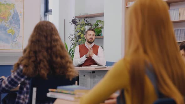 Girl Wants to Ask Teacher a Question By Raising a Hand in Classroom alt