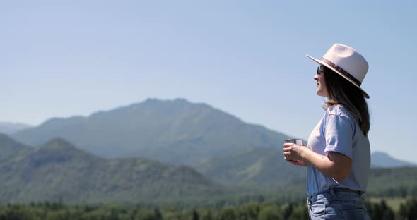 Young Woman Enjoying Nature and Admiring Scenery Views in Mountains, Side View