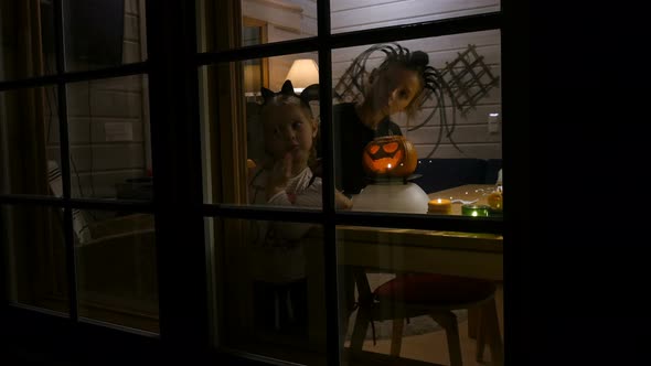  Halloween Pumpkin at Window. Children Playing at Home on Halloween Night.