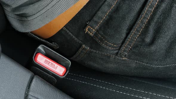 Car belt buckle disconecting from driver seat 4K footage alt