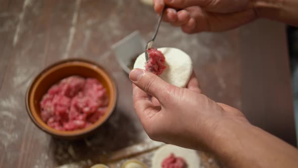 Preparing Pelmeni or Dumplings with Meat.