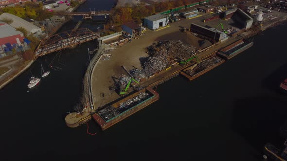 Aerial Descending Footage of Loading Scrap to Barge alt