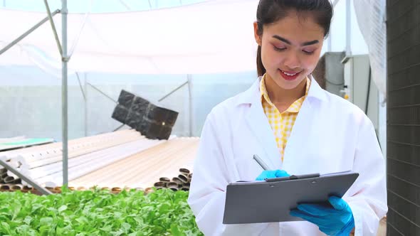 4k slow handheld asian female Hydroculture Specialist Studying Root Structure alt