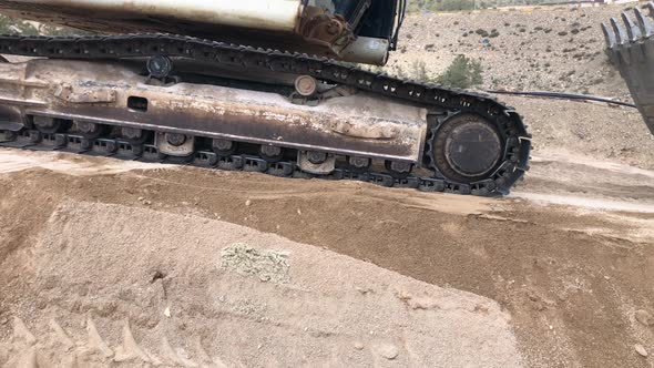 Excavator Drives By on Earth Embankment