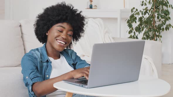 Happy African American Young Woman Do Remote Job From Home at Desk Smile Enjoy Telework Activity alt