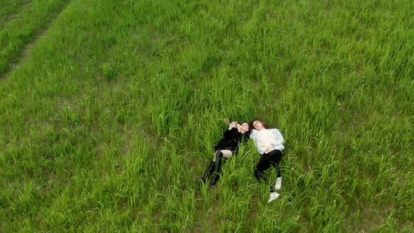 Top View of a Young Couple Lying in the Grass