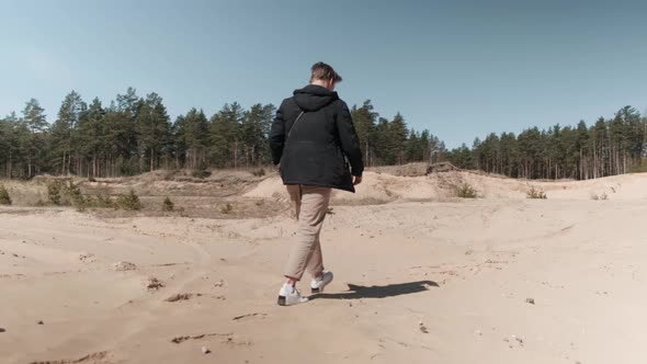 A Man Walks in the Sand Pits alt