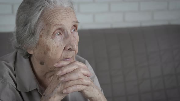 Pensive elderly woman.  alt