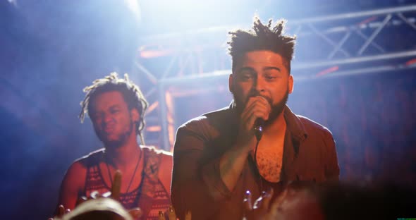 Singer performing on stage 4k alt