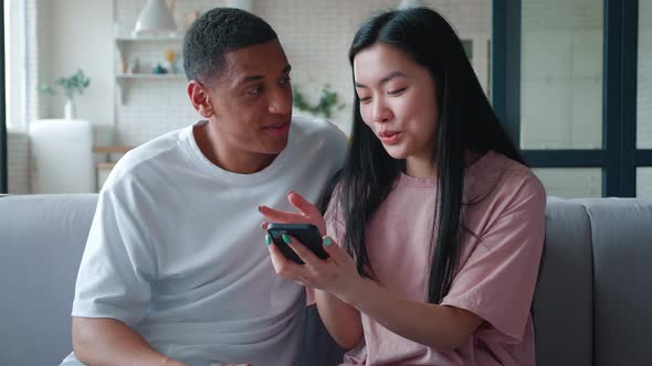 Cute Young Interracial Couple of African American Guy and His Asian Girlfriend Woman Communicating alt