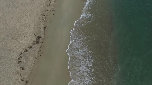 Aerial Drone View of Tropical Beach Ocean Waves Reaching Shore alt