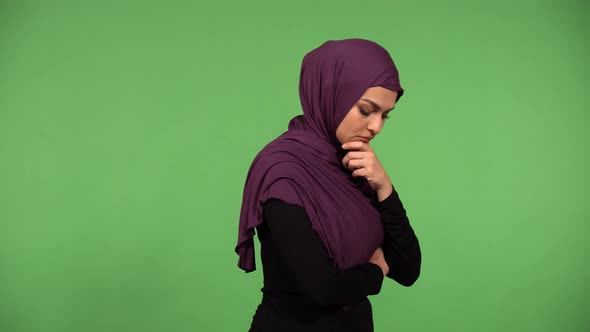 A Young Beautiful Muslim Woman Thinks About Something  Green Screen Background